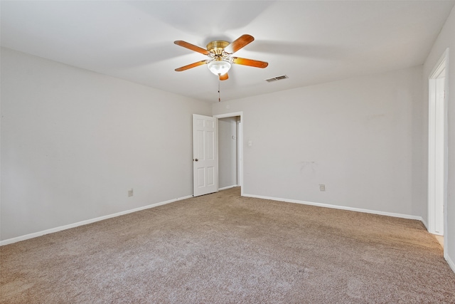 empty room with ceiling fan and light carpet