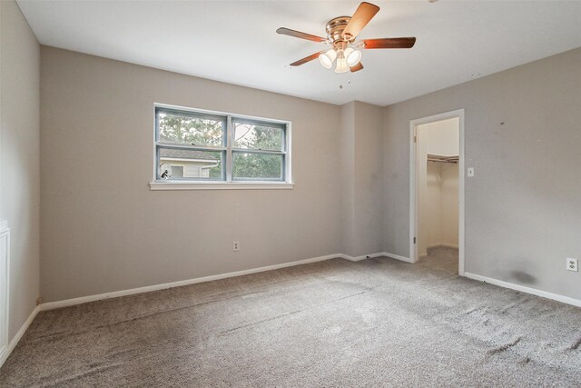 spare room with light colored carpet and ceiling fan