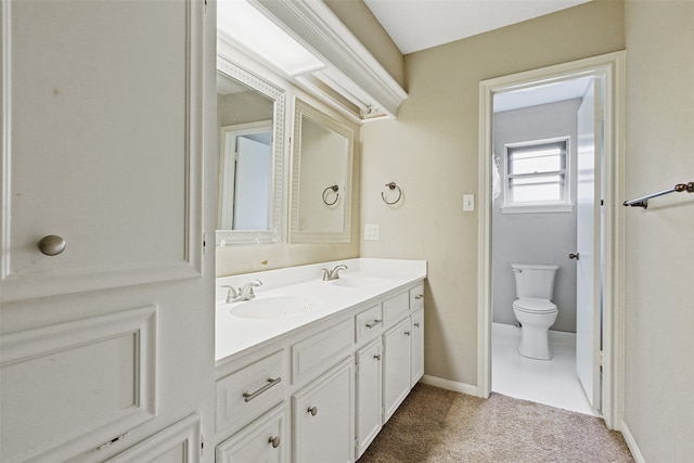 bathroom featuring toilet and vanity