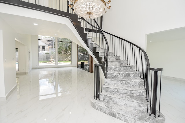 staircase featuring a notable chandelier