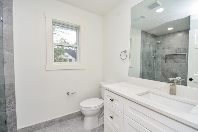 bathroom featuring vanity, toilet, an enclosed shower, and tile patterned flooring