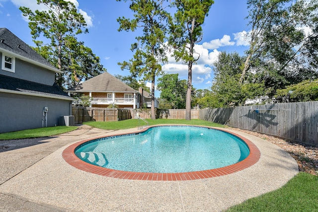 view of pool featuring a yard, a patio, and central AC