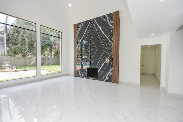 unfurnished room featuring crown molding, lofted ceiling, and plenty of natural light