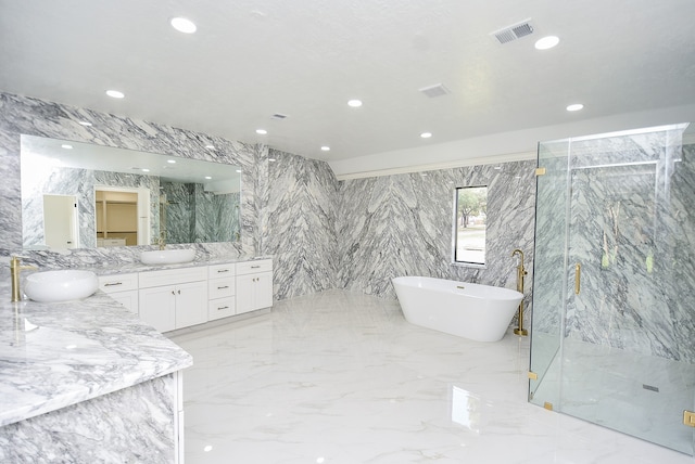 bathroom with tile walls, shower with separate bathtub, and vanity