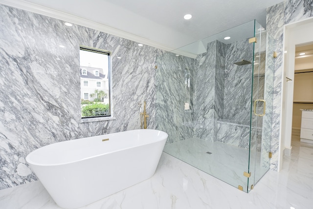 bathroom with tile walls and independent shower and bath