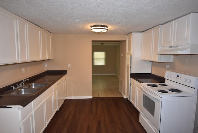 kitchen featuring dark wood finished floors, white appliances, white cabinetry, and a sink