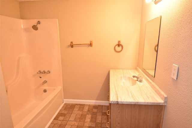 bathroom with vanity, baseboards, and washtub / shower combination