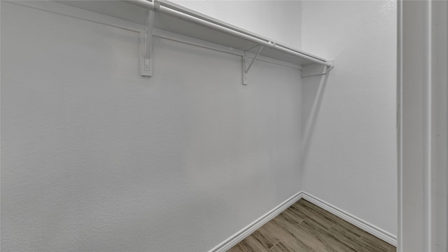 spacious closet with wood finished floors