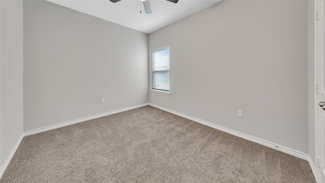 spare room with baseboards, a ceiling fan, and carpet flooring