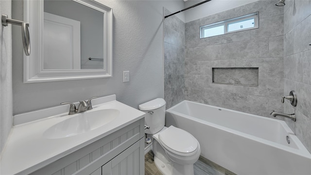 full bathroom featuring a textured wall, shower / bathtub combination, vanity, and toilet