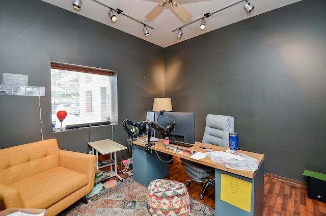 office area with rail lighting, ceiling fan, and dark hardwood / wood-style floors