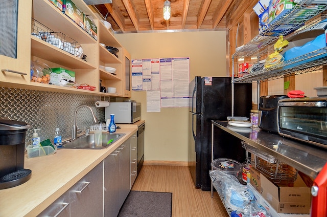 interior space featuring stainless steel appliances, light hardwood / wood-style floors, and sink