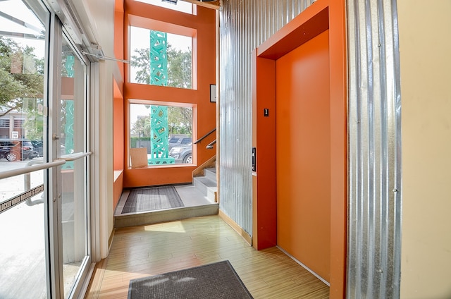 interior space with elevator and light hardwood / wood-style flooring