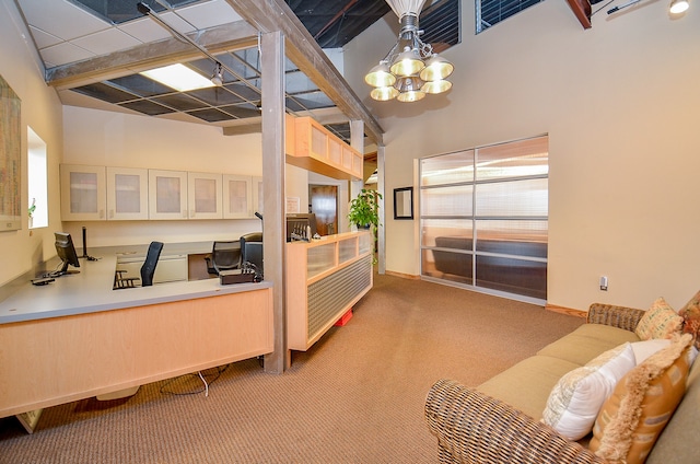 interior space with a chandelier, a high ceiling, and carpet