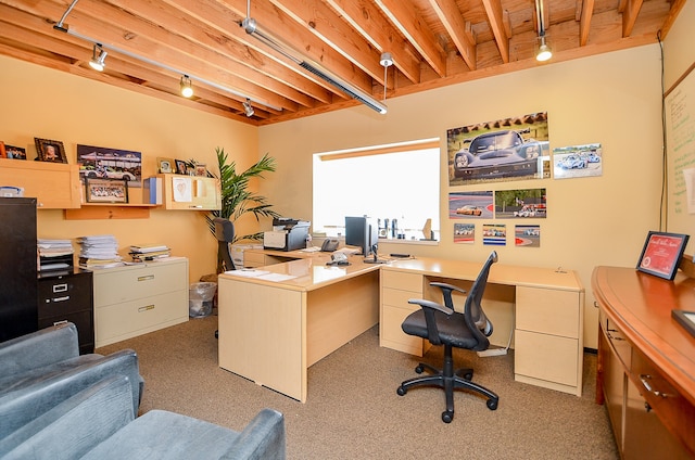 office featuring rail lighting and beamed ceiling