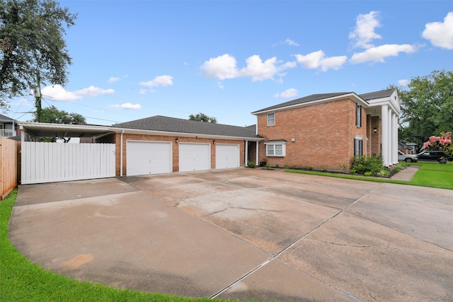 view of side of property featuring brick siding, concrete driveway, an attached garage, and fence