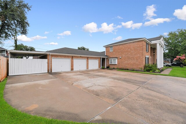 view of side of property featuring brick siding, concrete driveway, an attached garage, and fence