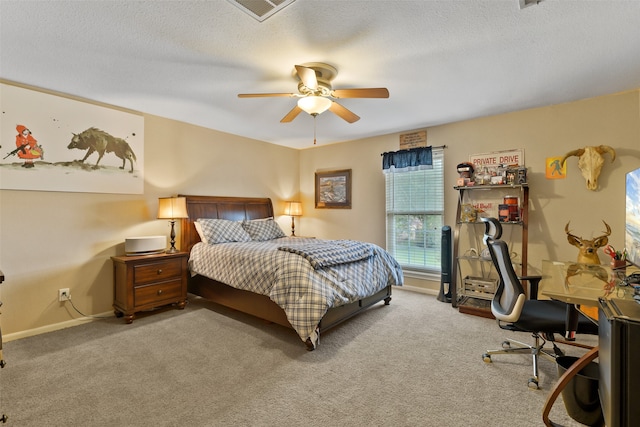 bedroom with a textured ceiling, ceiling fan, and carpet floors