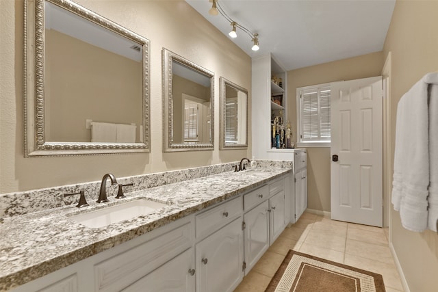 bathroom featuring tile patterned flooring and vanity