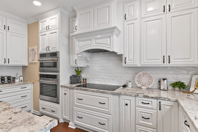 kitchen featuring tasteful backsplash, black electric stovetop, white cabinets, and dark hardwood / wood-style floors