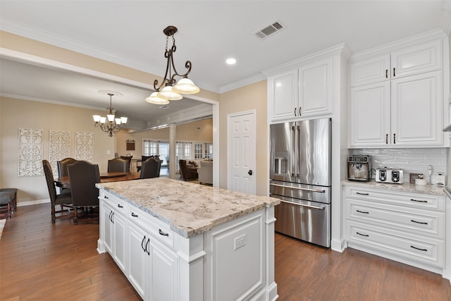 kitchen with high end fridge, white cabinetry, decorative light fixtures, and dark hardwood / wood-style floors