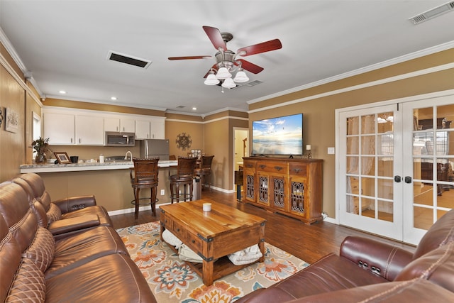 living room featuring crown molding, dark hardwood / wood-style flooring, and ceiling fan