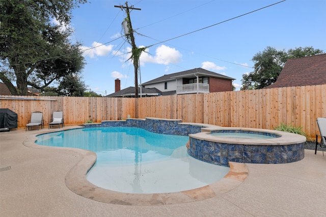 view of pool featuring a patio area and an in ground hot tub