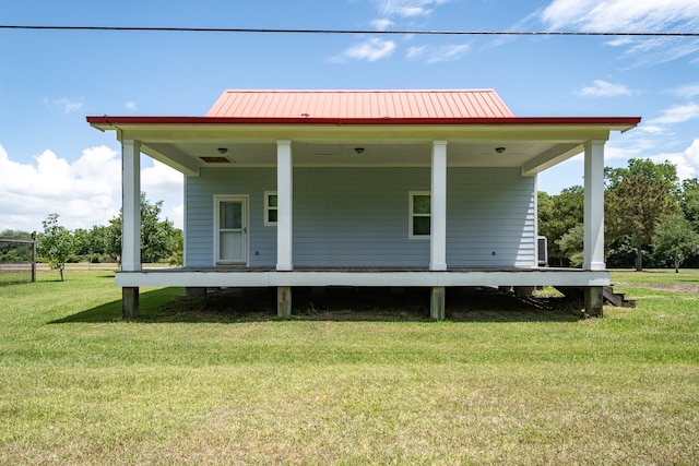 rear view of house featuring a lawn