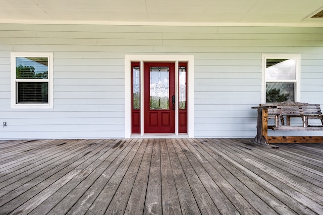 entrance to property featuring a wooden deck