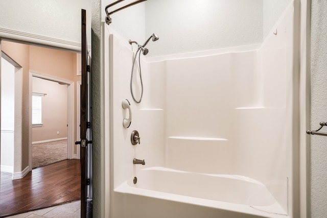 bathroom featuring bathing tub / shower combination and hardwood / wood-style floors