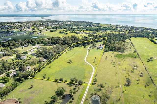 drone / aerial view featuring a rural view and a water view