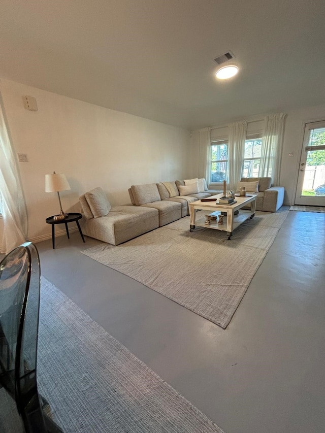 unfurnished living room with concrete flooring