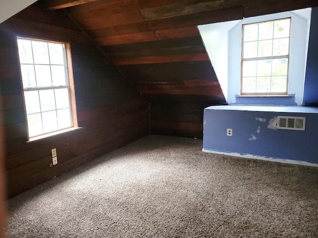 additional living space featuring lofted ceiling with beams, carpet floors, wooden walls, and wooden ceiling