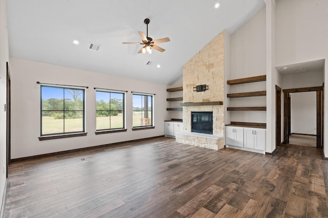 unfurnished living room featuring a fireplace, high vaulted ceiling, ceiling fan, and dark wood-type flooring