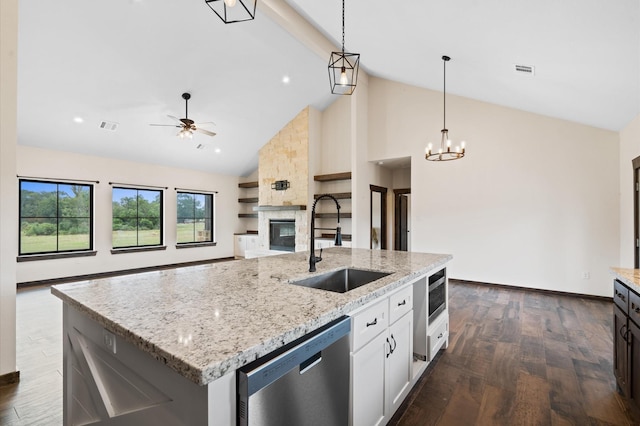 kitchen featuring sink, an island with sink, hanging light fixtures, and appliances with stainless steel finishes