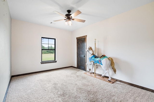 empty room featuring ceiling fan and carpet floors