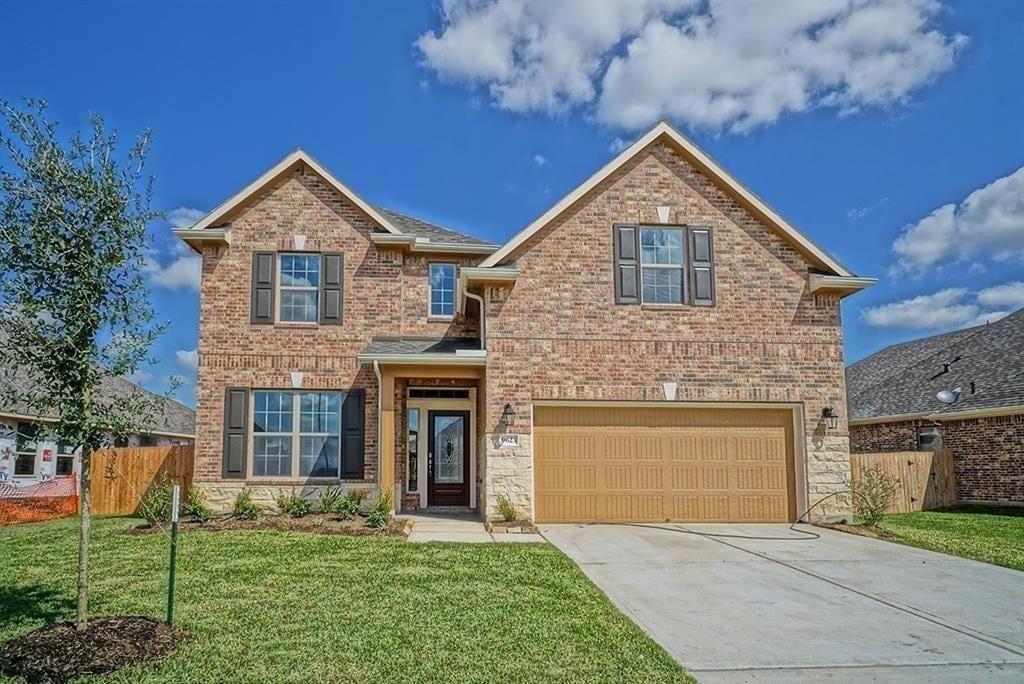 front facade with a front yard and a garage