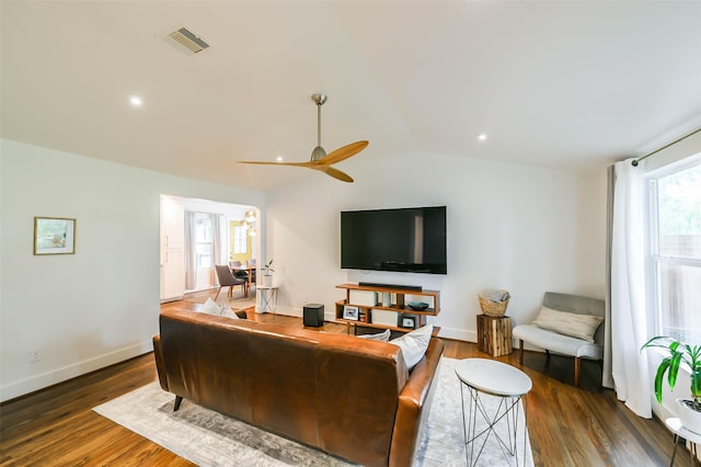 living room with ceiling fan, dark hardwood / wood-style flooring, and lofted ceiling