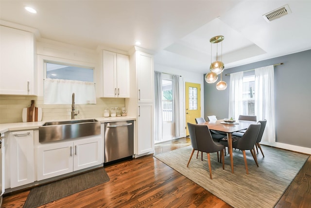 kitchen featuring dishwasher, sink, hanging light fixtures, a tray ceiling, and white cabinetry