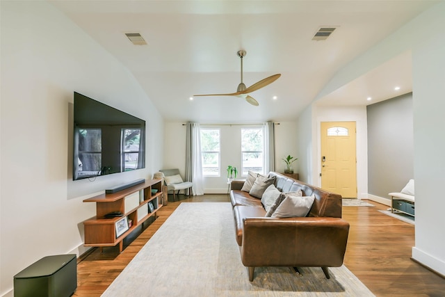 living room featuring hardwood / wood-style floors, vaulted ceiling, and ceiling fan