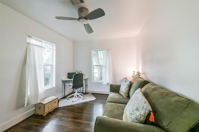 office featuring a wealth of natural light, ceiling fan, and dark wood-type flooring