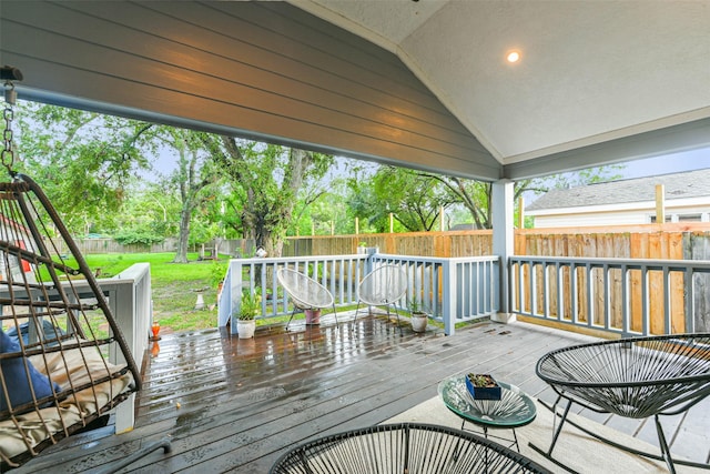 wooden terrace with a lawn