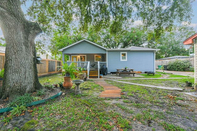 rear view of house with covered porch