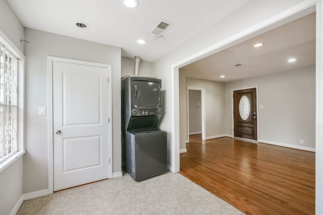 interior space featuring light hardwood / wood-style floors and stacked washer and clothes dryer