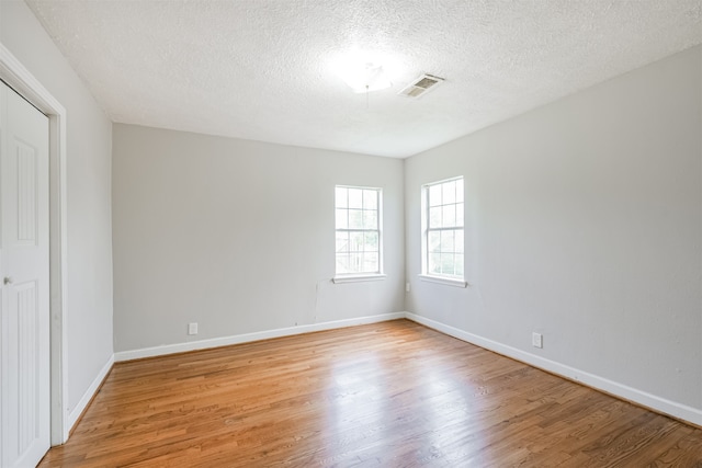 interior space featuring a textured ceiling and light hardwood / wood-style flooring