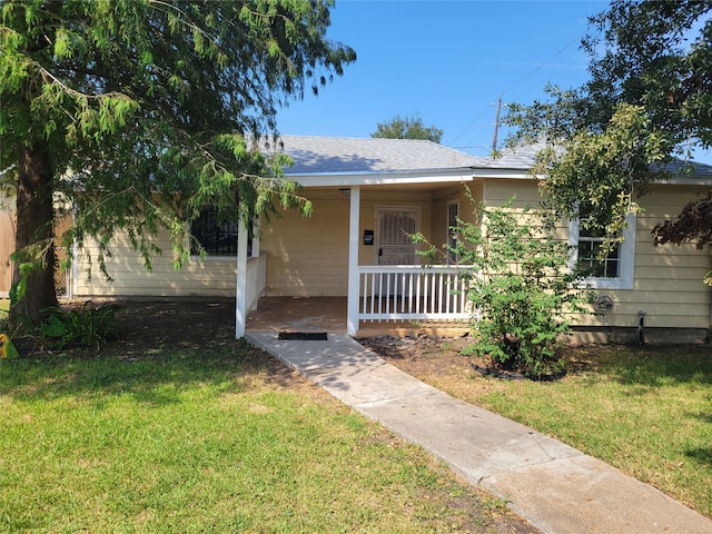 view of front of house featuring a front yard and covered porch