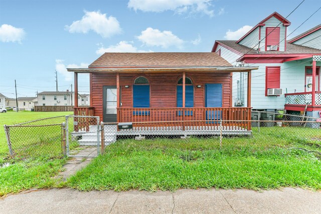 view of front facade with a porch, a front lawn, and cooling unit