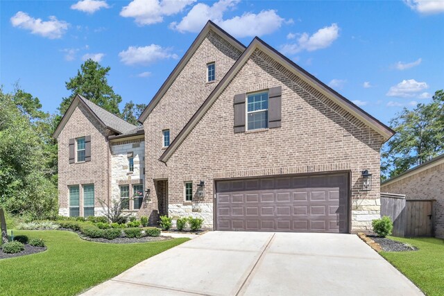 view of front of house featuring a garage and a front lawn