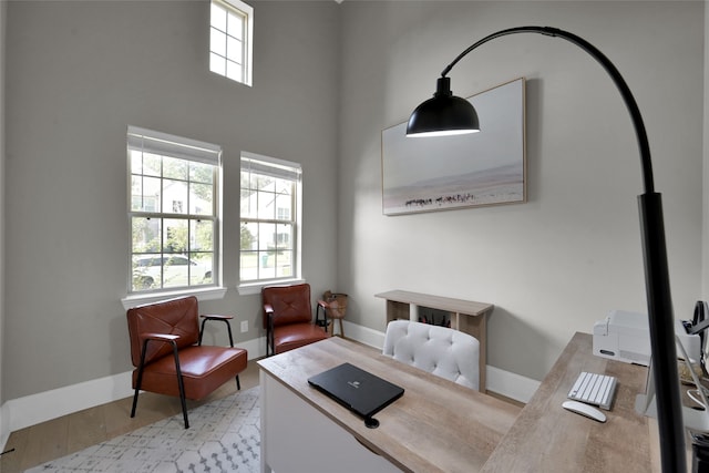 home office with light hardwood / wood-style floors