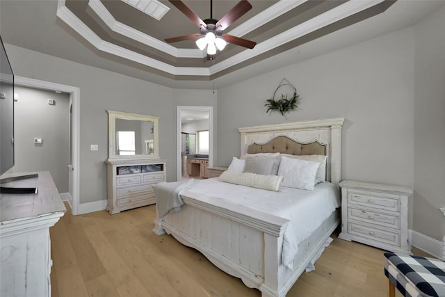 bedroom with ceiling fan, a raised ceiling, crown molding, and light hardwood / wood-style flooring